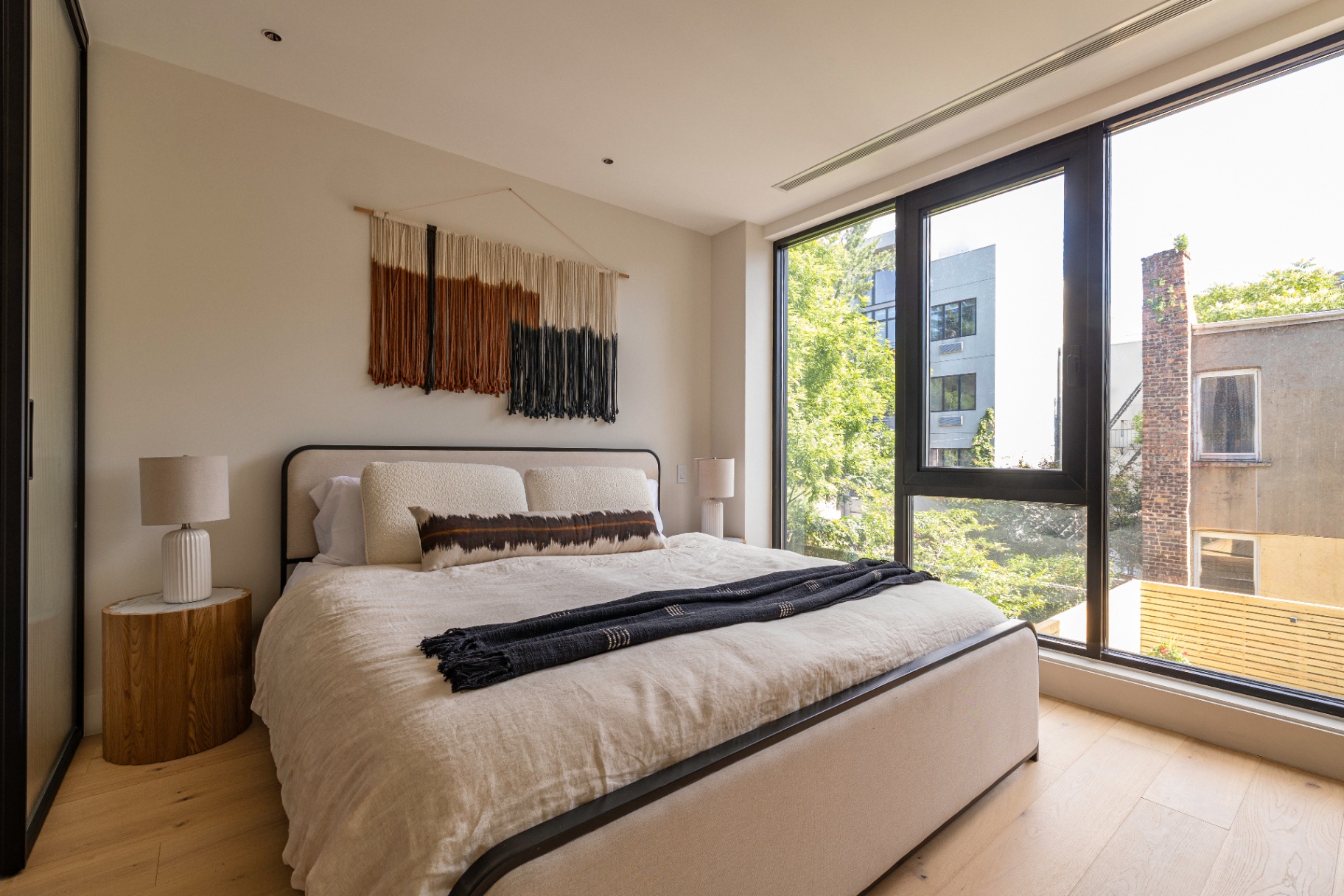Residence 2B primary bedroom with floor-to-ceiling windows