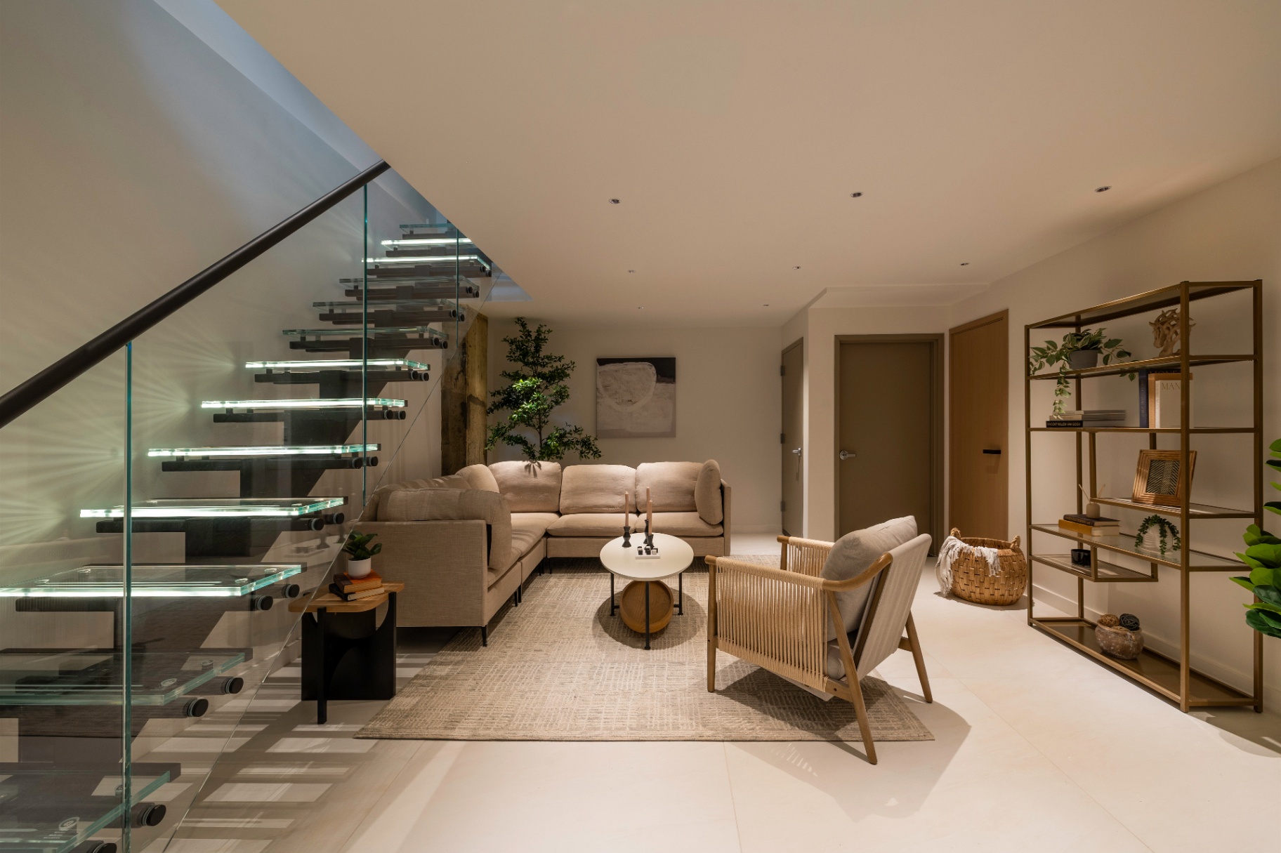 Residence 1B lower-level lounge and tempered glass staircase